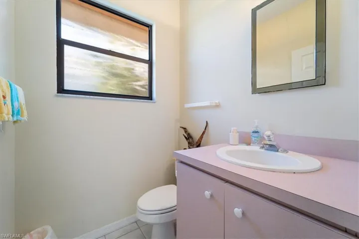 Bathroom featuring tile patterned flooring, vanity, and toilet