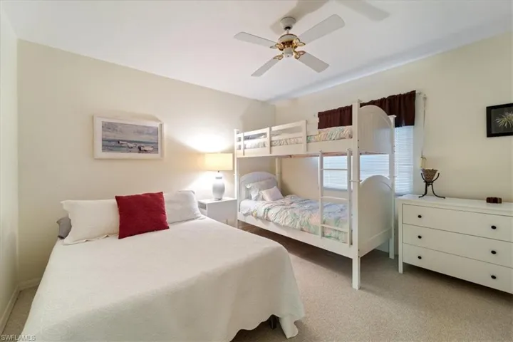 Carpeted bedroom with ceiling fan