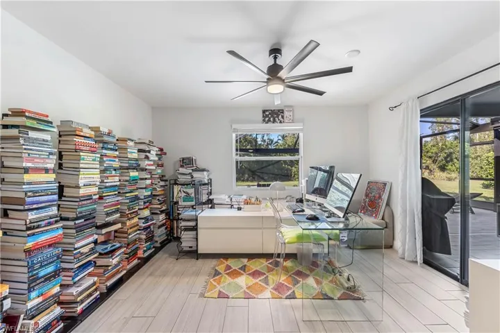 Home office featuring light wood-type flooring, a wealth of natural light, and ceiling fan