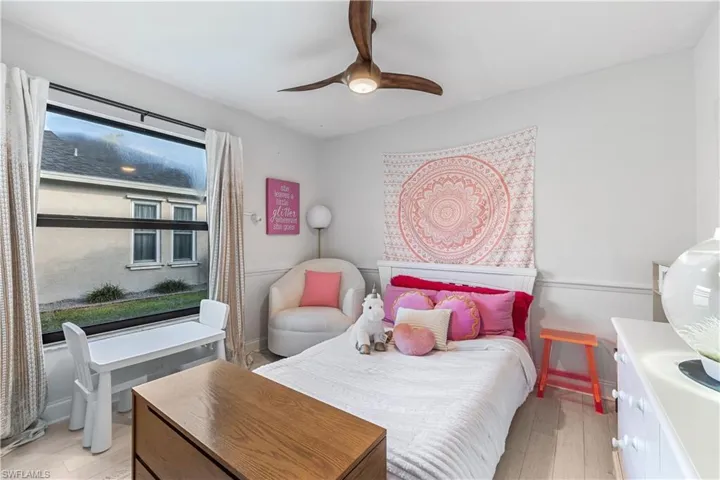 Bedroom with ceiling fan and light hardwood / wood-style flooring