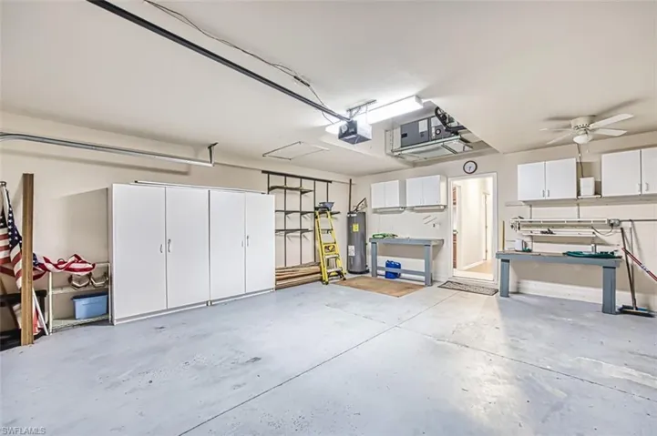 Garage with electric water heater and a garage door opener