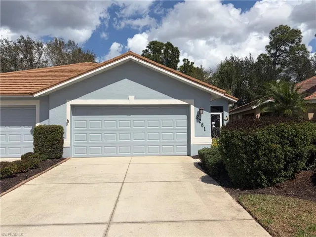 Ranch-style home with stucco siding, driveway, and an attached garage