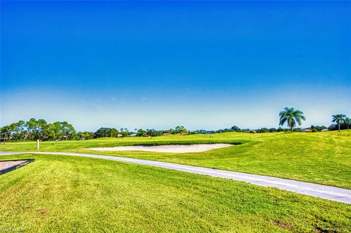 View of home's community featuring a lawn and golf course view