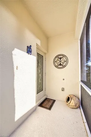 Property entrance featuring stucco siding
