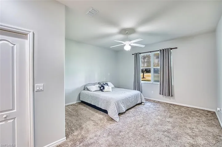 Bedroom with carpet floors and a ceiling fan