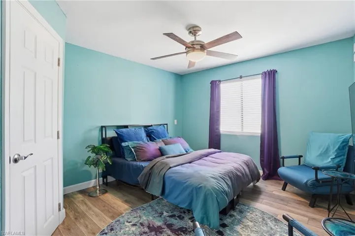 Bedroom featuring wood finished floors and a ceiling fan
