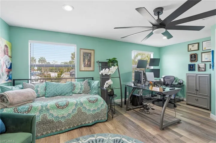 Home office with wood finished floors, recessed lighting, and a ceiling fan