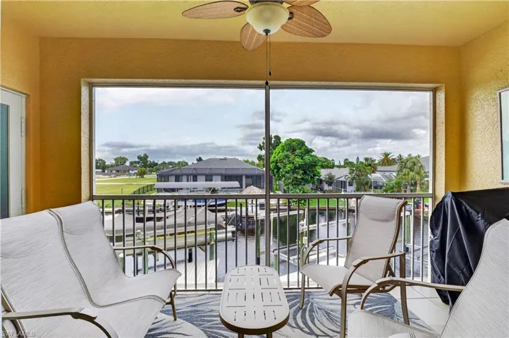 Screened balcony with textured walls and ceiling fan