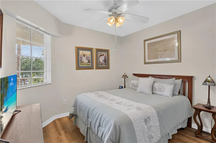 Wood-finish flooring, recessed window, and ceiling fan with integrated lighting