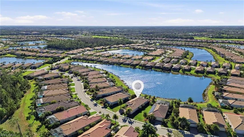 Aerial perspective of suburban area featuring a large body of water