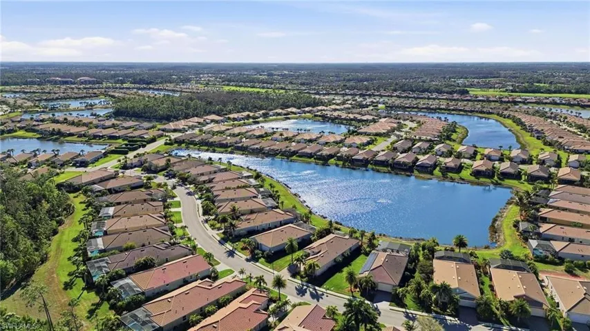 Aerial perspective of suburban area featuring a large body of water