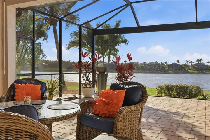 Sunroom / solarium with a water view and a patio area