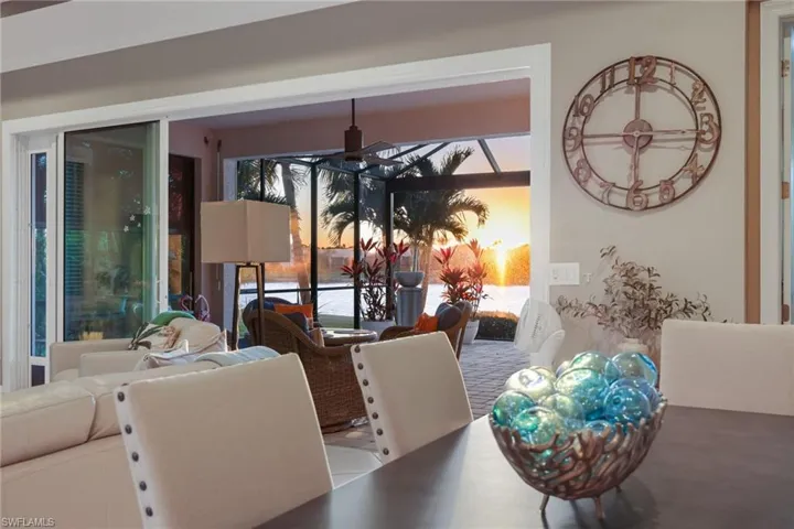 Dining area with a sunroom and a ceiling fan
