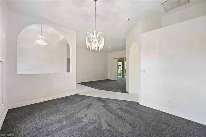 The formal dining room has a large window looking out towards the front of the home.