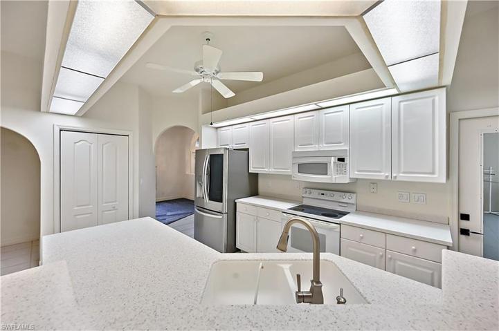 A very large kitchen with bright corian countertops