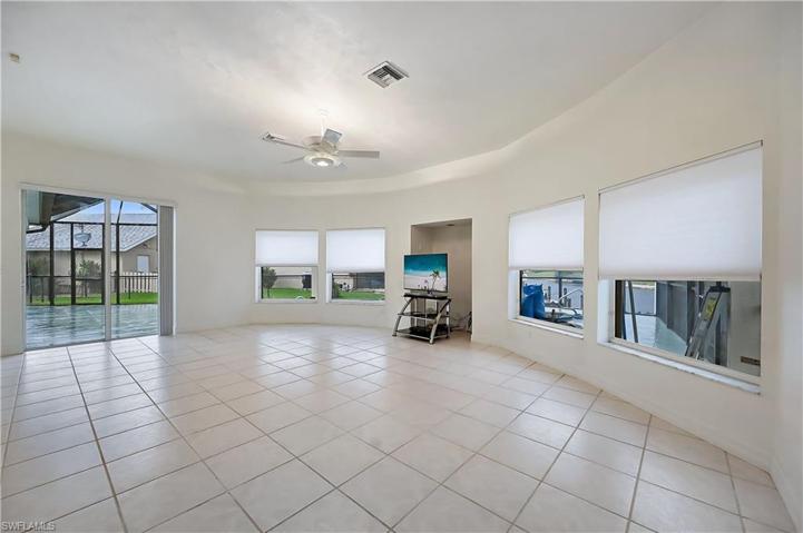 Large family room with windows overlooking the pool and saltwater canal