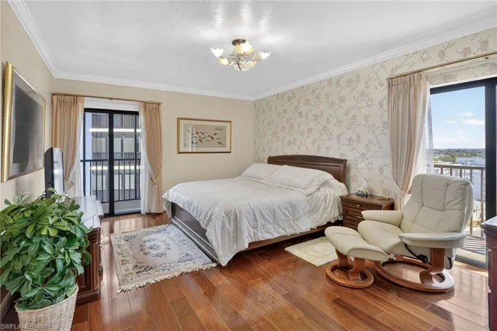 Large primary bedroom with two balconies