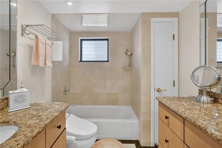 Primary bathroom features separate walk in shower and soaking tub