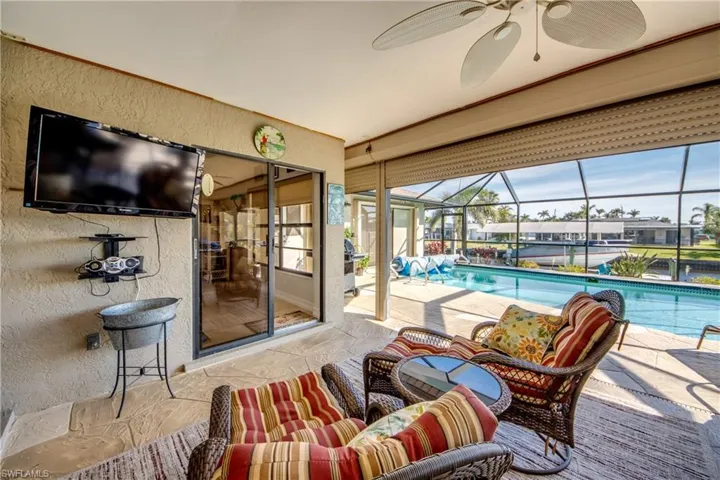View of pool featuring ceiling fan