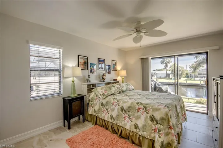 Bedroom with ceiling fan and access to outside