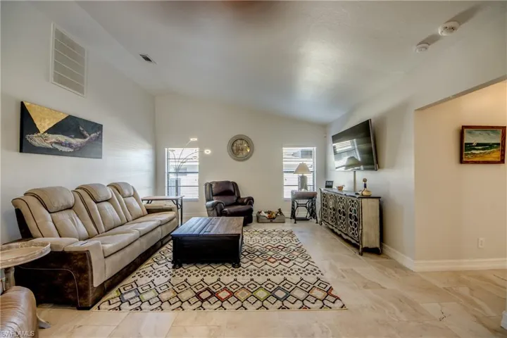 Living room featuring vaulted ceiling