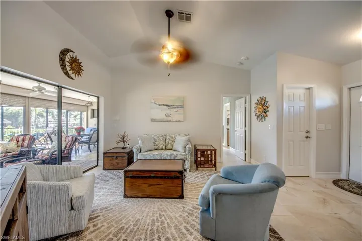 Living room with lofted ceiling and ceiling fan