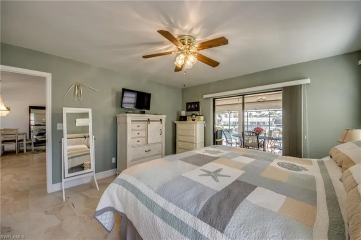 Bedroom with access to outside and ceiling fan