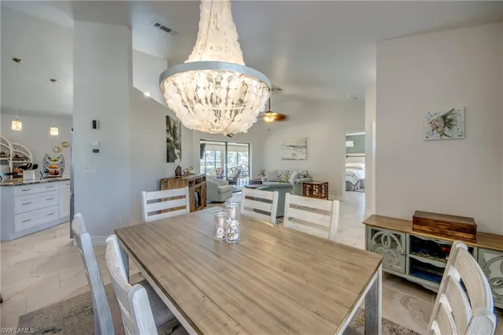 Dining area with vaulted ceiling and a chandelier