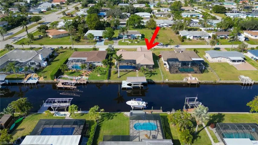 Birds eye view of property with a water view