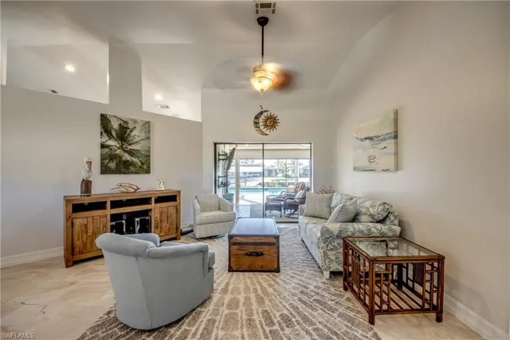 Living room with high vaulted ceiling and ceiling fan