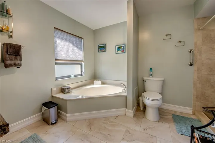 Bathroom featuring independent shower and bath and toilet