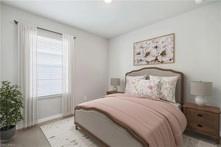 Bedroom featuring light carpet