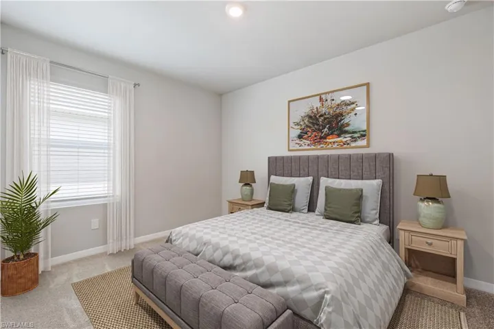 Bedroom featuring light carpet