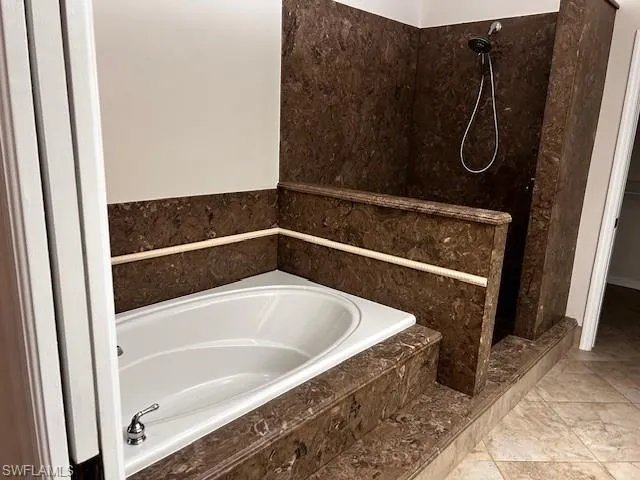 Bathroom with a bath and a shower