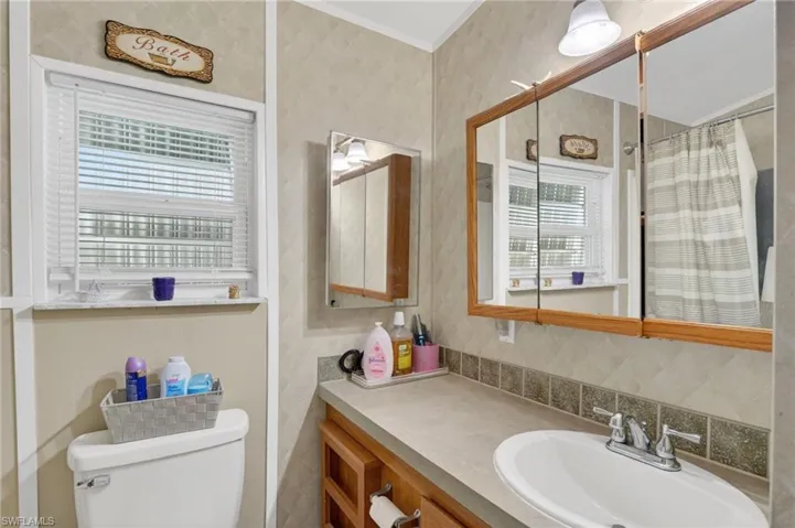 Full bath featuring vanity and curtained shower