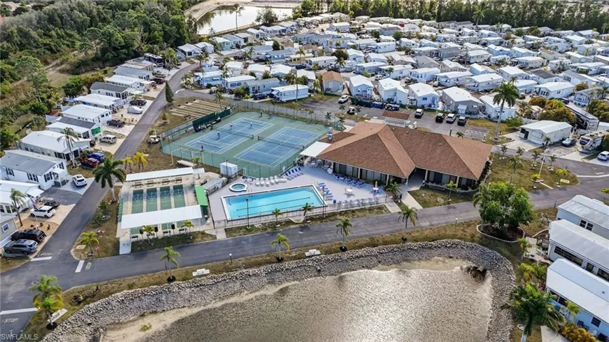 Aerial view of property's location with nearby suburban area and a large body of water