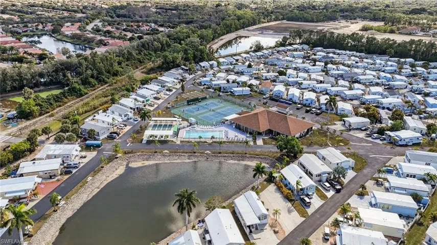 Aerial view of property's location featuring a large body of water and nearby suburban area