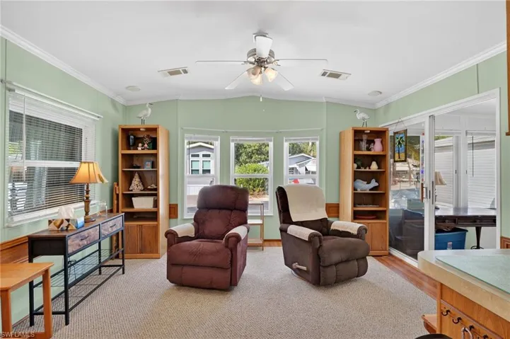 Sitting room featuring crown molding and a ceiling fan