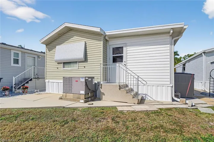 Back of property with a lawn