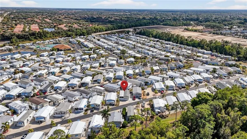 Aerial view of property's location featuring nearby suburban area