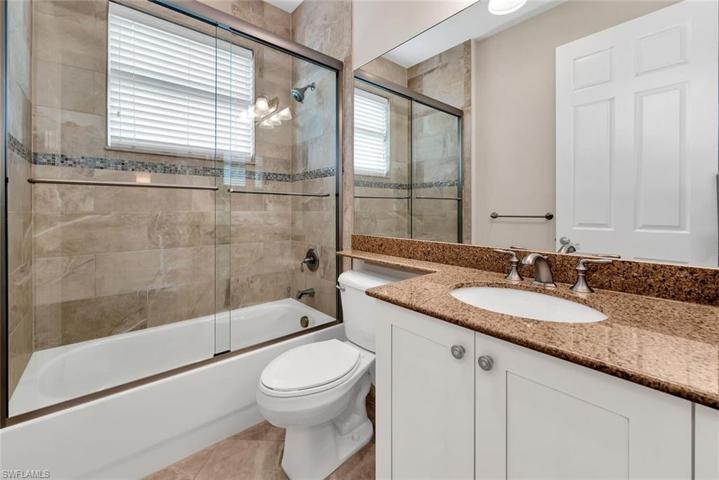 Guest bath with a tub and upgraded frameless shower door.