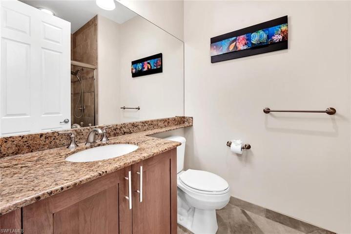 Another guest bath with a walk in shower featuring a frameless shower door.