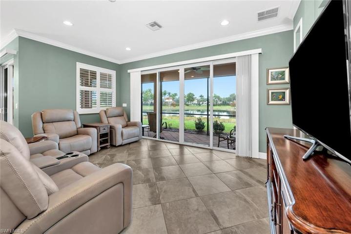 Freshly painted family room featuring: plantation shutters, impact glass, ceramic tile and crown molding.