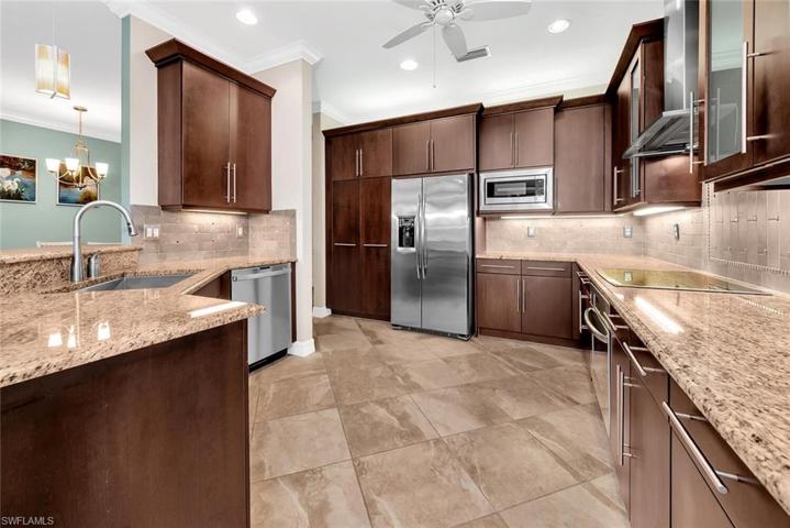 Designer kitchen with upgraded cabinets with pull out draws, commercial grade range hood that vents outside.