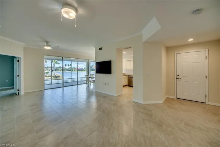 Foyer and Living Room with mounted TV included
