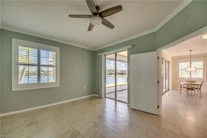 Primary Bedroom featuring crown molding, plantation shutter and ceiling fan
