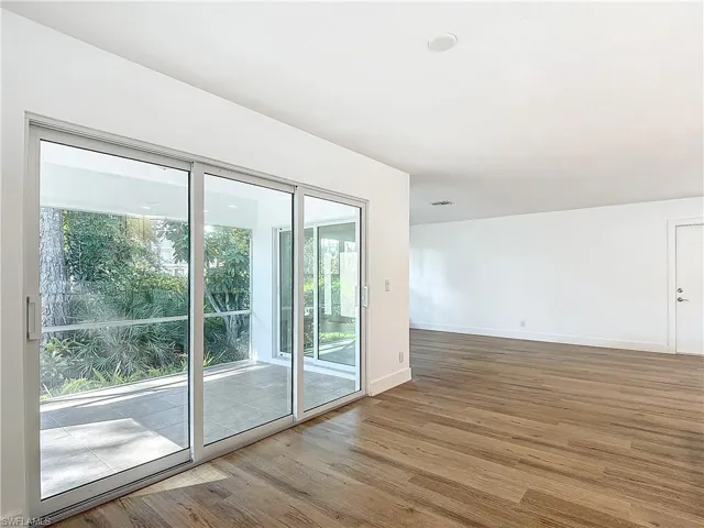 Unfurnished room featuring light hardwood / wood-style floors and a wealth of natural light