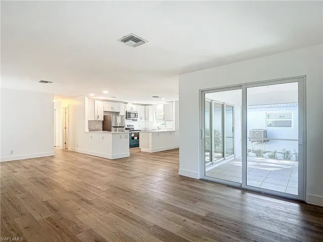 Unfurnished living room with hardwood / wood-style floors