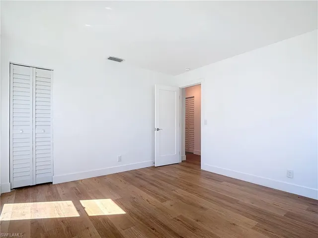 Unfurnished bedroom with a closet and light hardwood / wood-style floors