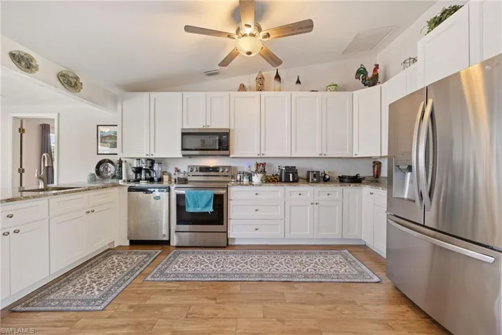 Kitchen with granite tops, white shaker style cabinets